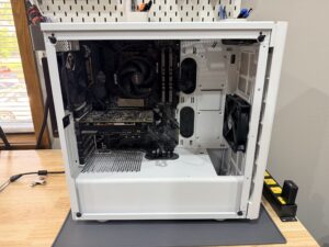 White gaming PC with RGB lighting during cleaning and diagnosis.